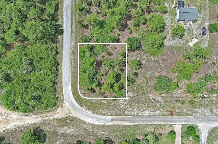 Aerial view of property and surrounding area with property boundaries highlighted