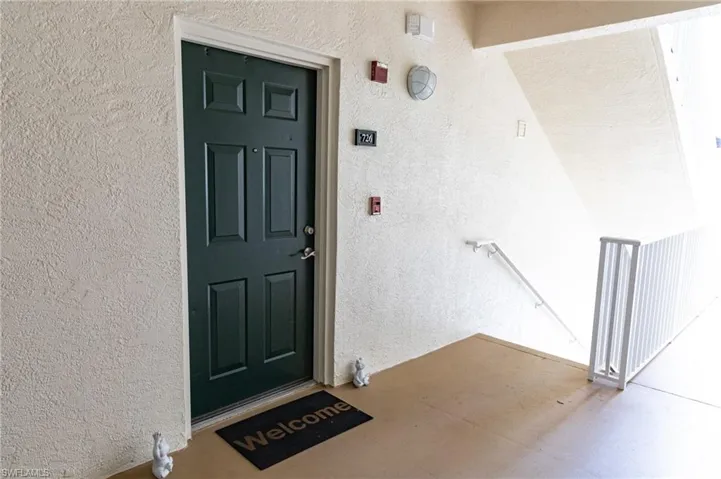 Property entrance featuring stucco siding