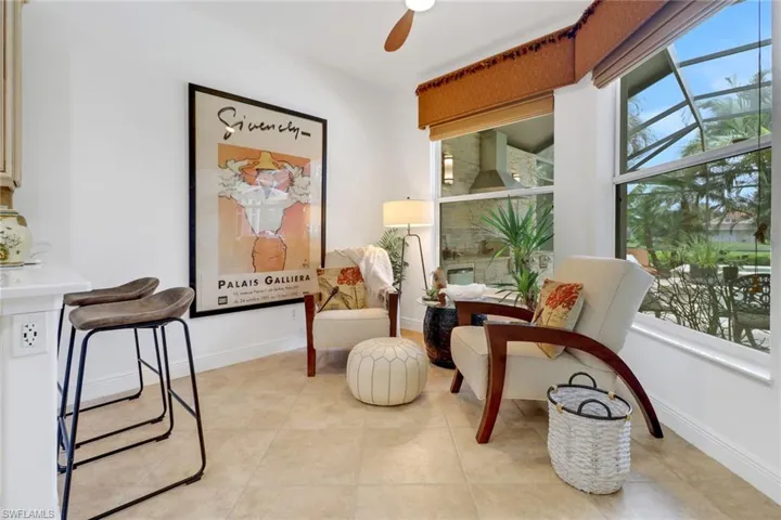 Sitting room featuring light tile patterned floors and ceiling fan