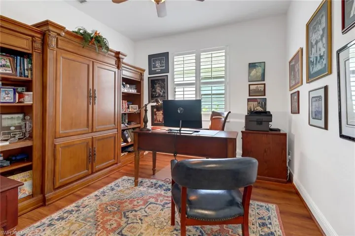 Office space with ceiling fan and wood-type flooring