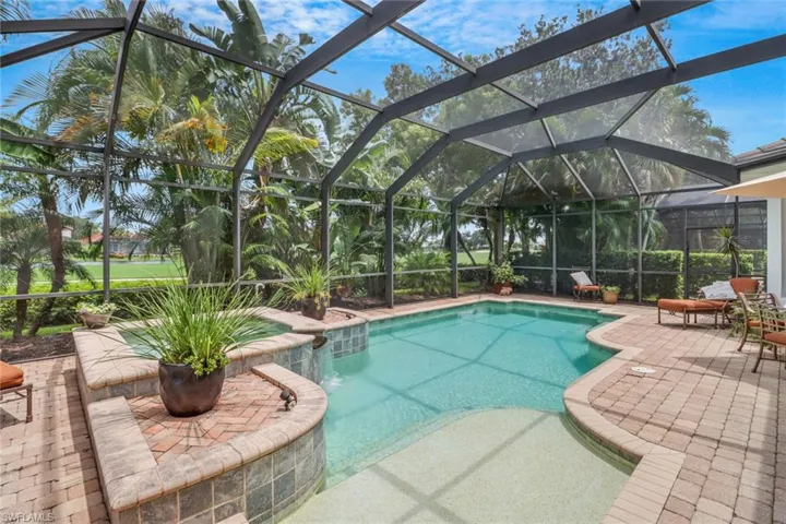 View of swimming pool with a lanai and a patio