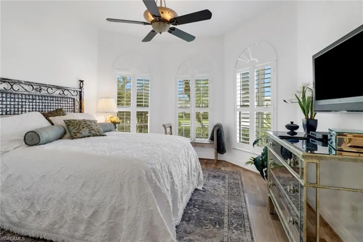 Bedroom featuring ceiling fan and dark hardwood / wood-style floors