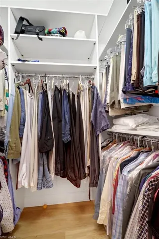 Spacious closet featuring light hardwood / wood-style floors
