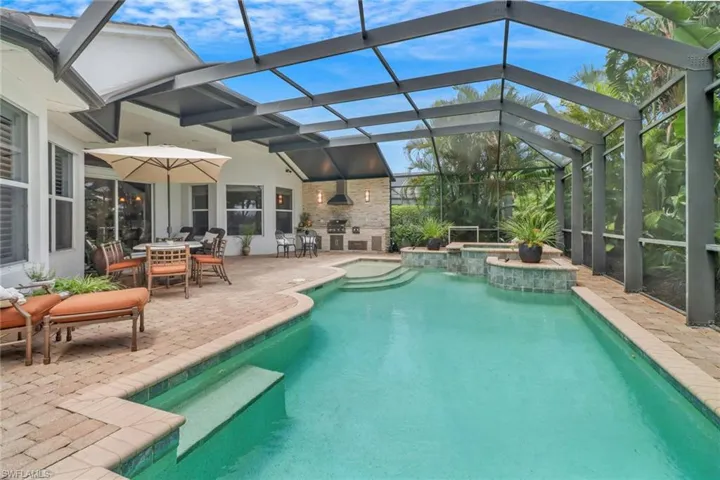 View of pool with a patio and a lanai
