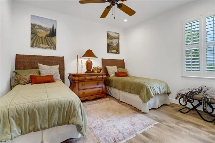 Bedroom with ceiling fan and light hardwood / wood-style floors