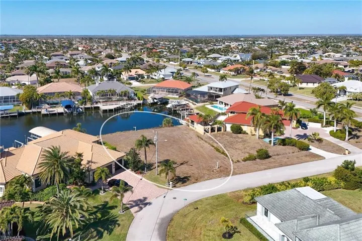 Aerial view of residential area featuring a large body of water