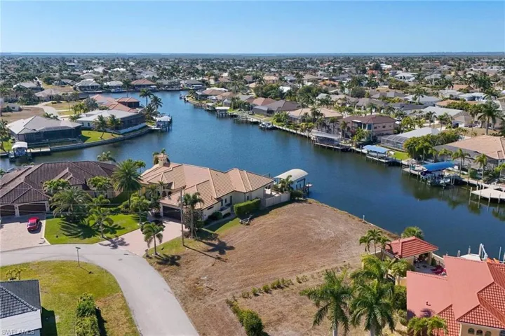 Aerial perspective of suburban area with a nearby body of water