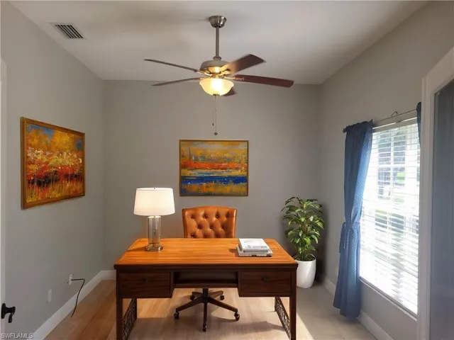 Home office or den features plenty of natural lighting overlooking the front lawn. Virtually staged