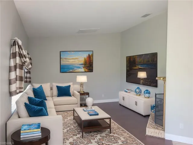 Living room with dark wood-type flooring, virtually staged