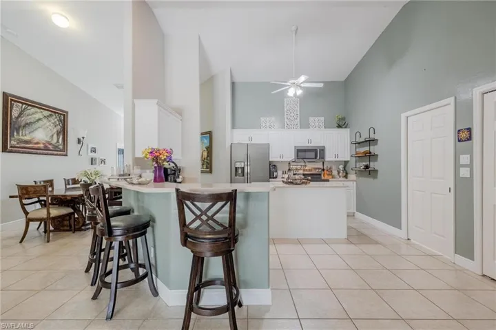 The bright kitchen offers a breakfast bar and a generously sized pantry.