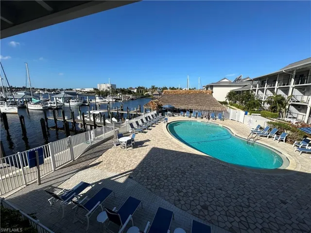 View of swimming pool featuring a patio and a water view