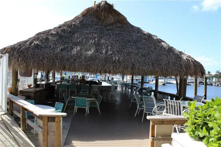 Dock area with a deck with water view, an outdoor bar, and a gazebo