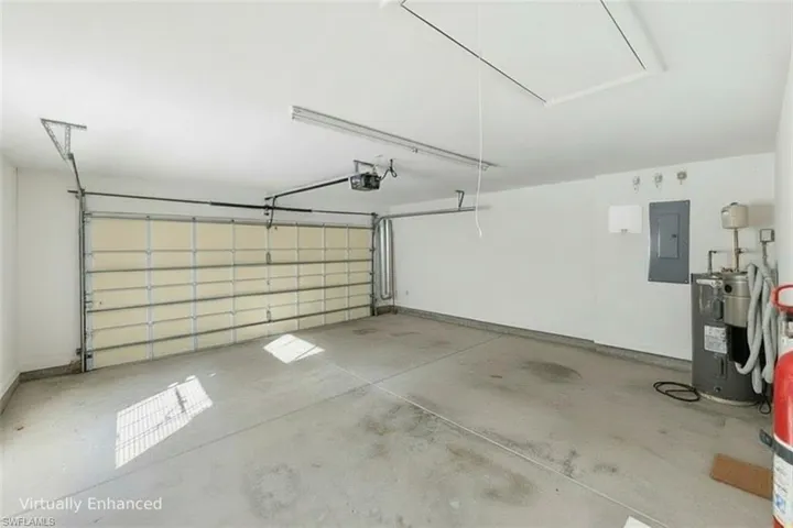Virtually emptied-out 2-Car Garage with Waterheater