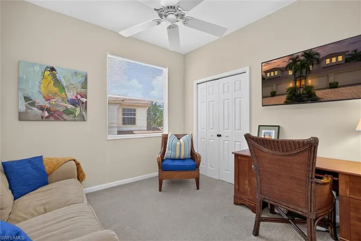 Bright room featuring neutral wall paint, carpet flooring, a ceiling fan, a window with horizontal blinds, and bi-fold closet doors