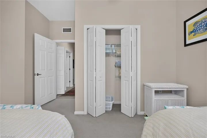 Bedroom featuring light beige walls and gray carpet flooring