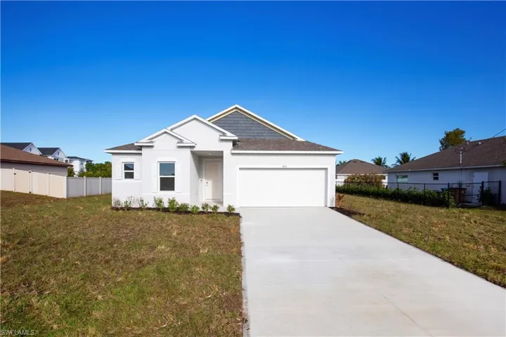 View of front of home with concrete driveway, a garage, and stucco siding