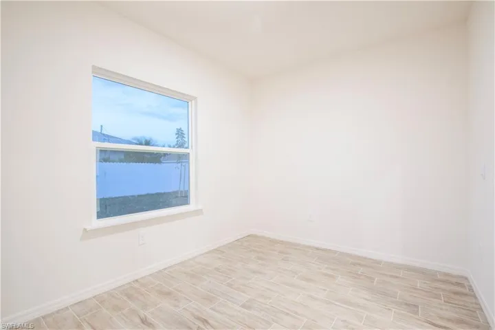 Spare room with wood finish floors and baseboards