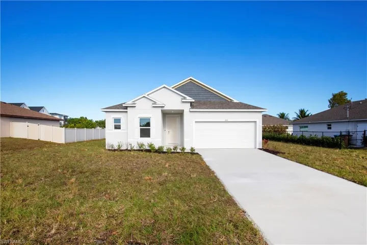 View of front facade with an attached garage, stucco siding, concrete driveway, and roof with shingles