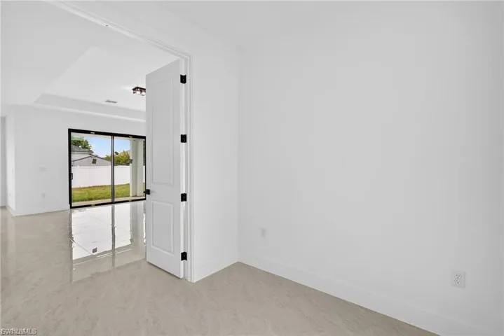 Unfurnished room featuring baseboards and a tray ceiling