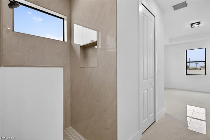 Bathroom with a walk in shower and baseboards