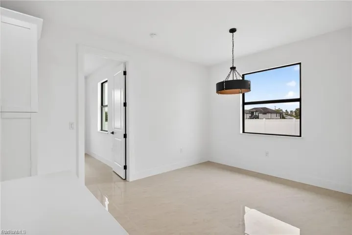 Unfurnished dining area with baseboards