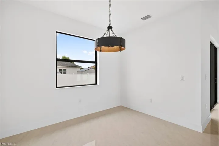Unfurnished dining area with baseboards