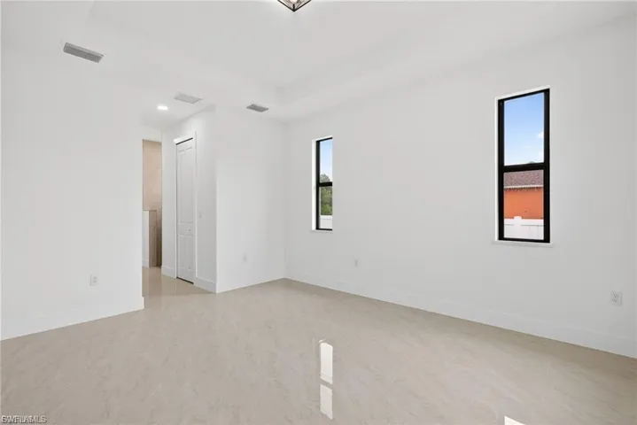 Spare room featuring a raised ceiling and recessed lighting