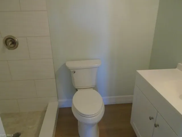Bathroom with a shower, vanity, and toilet