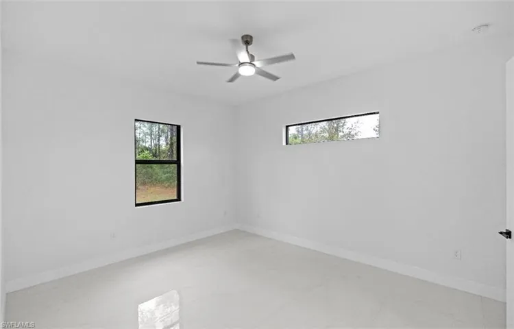 Spare room featuring plenty of natural light and ceiling fan