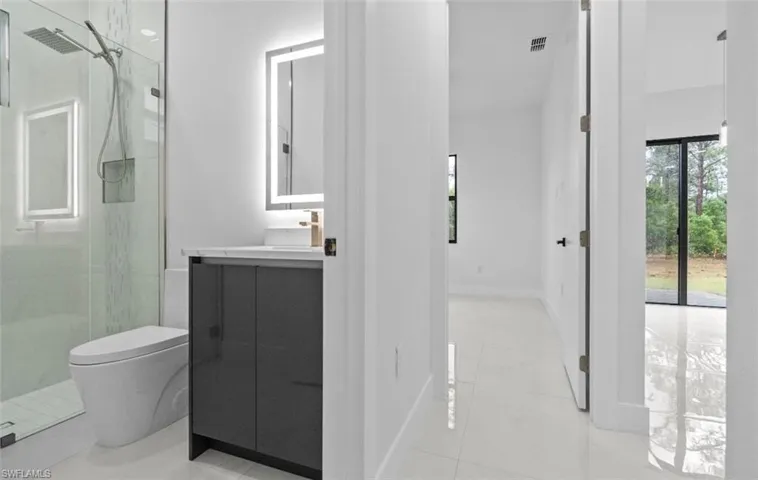 Full bathroom with vanity and a shower stall