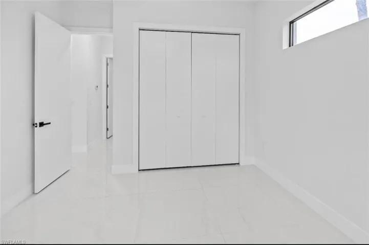 Unfurnished bedroom with baseboards and a closet