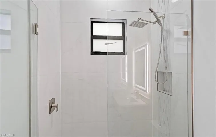 Bathroom featuring a marble finish shower