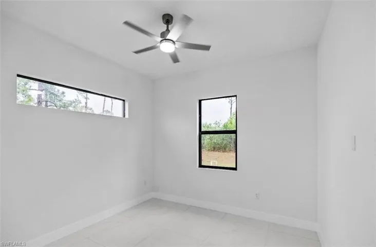 Unfurnished room featuring baseboards and a ceiling fan