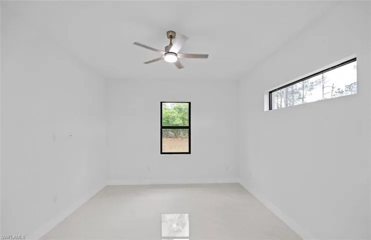 Unfurnished room featuring baseboards and a ceiling fan