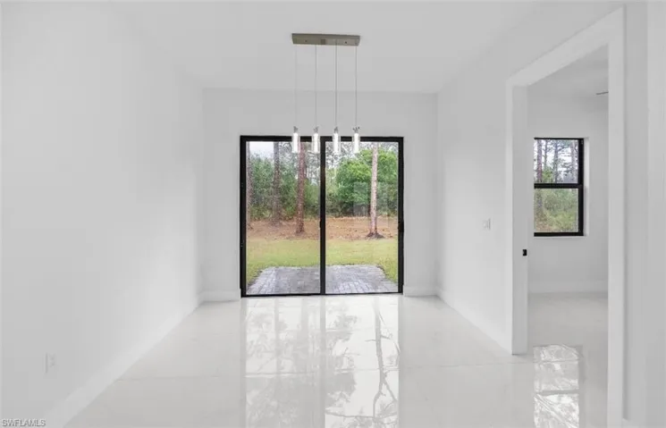 Unfurnished dining area featuring baseboards