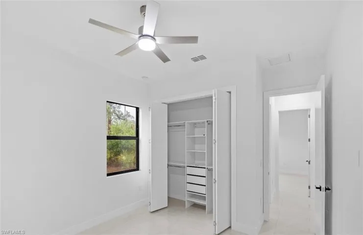 Unfurnished bedroom with a closet and a ceiling fan
