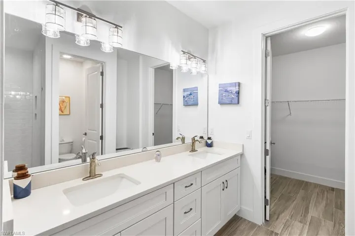 Dual quartz countertop vanitiy. Walk in closet.