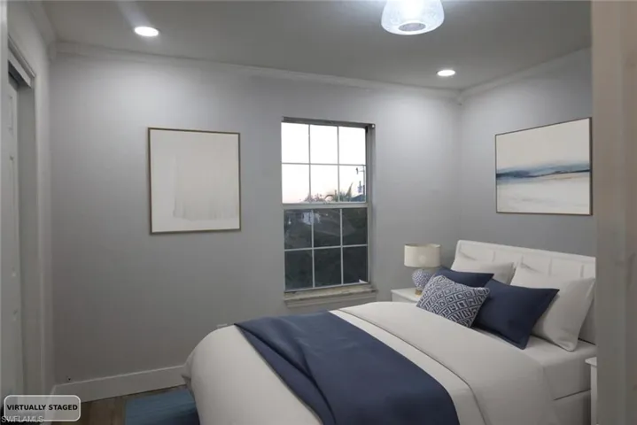Bedroom with ornamental molding, wood finished floors, and recessed lighting