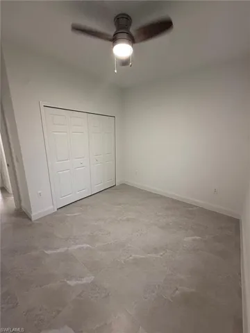 Unfurnished bedroom with a closet and ceiling fan