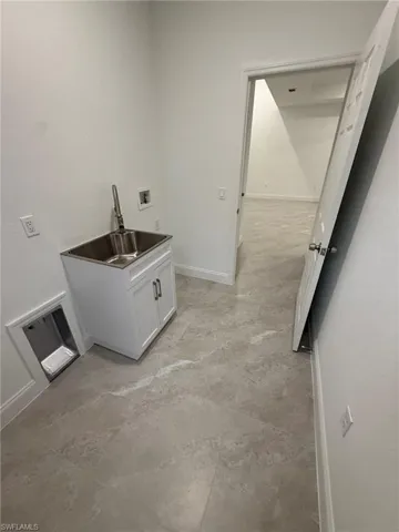 Washroom featuring baseboards and washer hookup