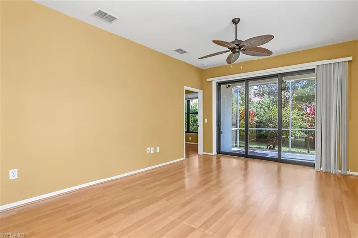 Great room is perfect for entertaining guests or relaxing with family. All windows and doors (including lanai sliding doors) are impact resistant and were recently replaced.