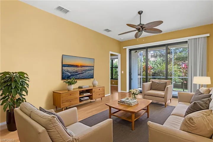 Great room is perfect for entertaining guests or relaxing with family. All windows and doors (including lanai sliding doors) are impact resistant and were recently replaced. *photo digitally staged