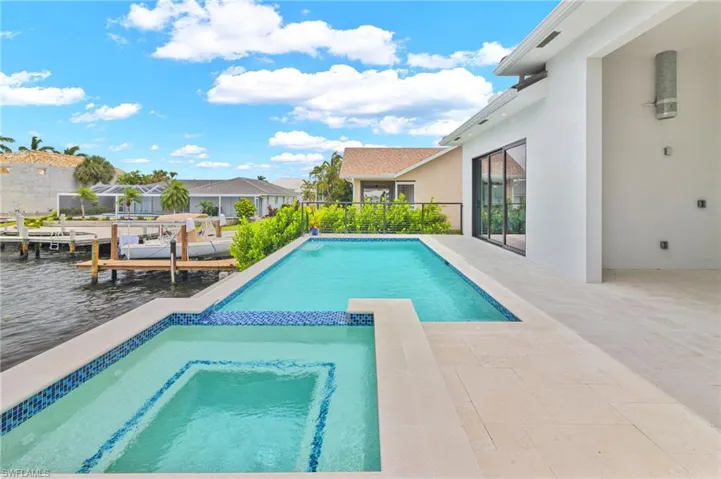 View of pool featuring a boat dock and a patio area