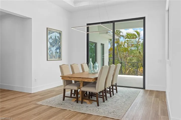 Dining area with light hardwood / wood-style flooring and a wealth of natural light