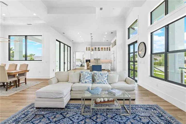 Living room with a towering ceiling and hardwood / wood-style floors