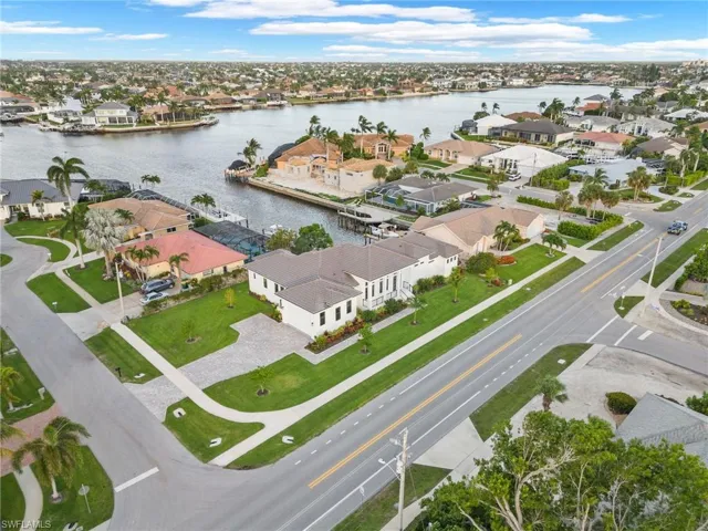 Birds eye view of property with a water view