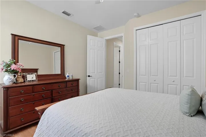 Bedroom featuring a closet, wood finished floors, and ceiling fan