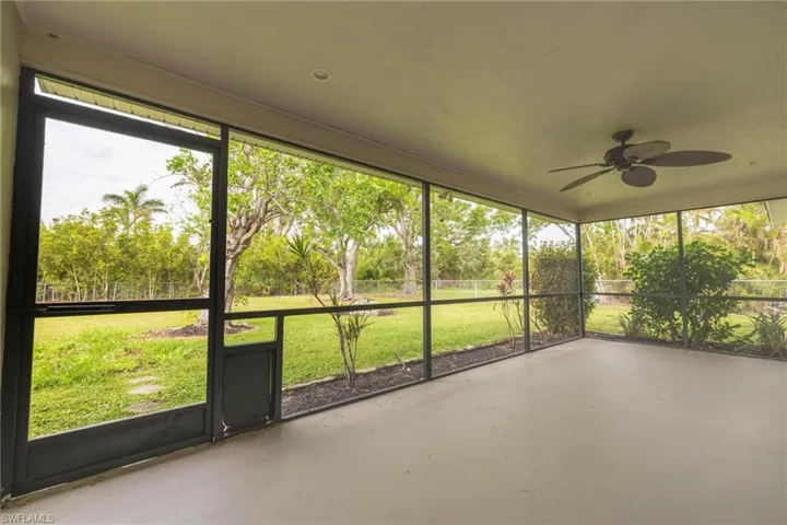 Unfurnished sunroom featuring ceiling fan
