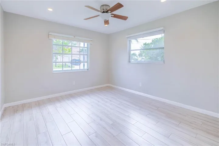 Empty room featuring a wealth of natural light and light hardwood / wood-style flooring