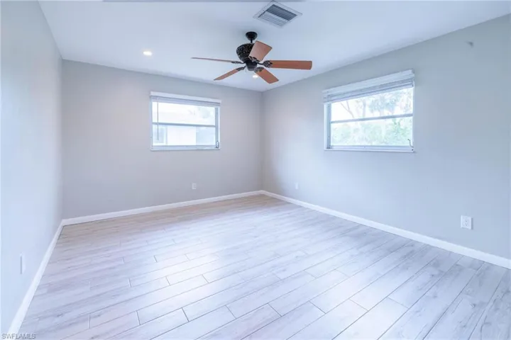 Unfurnished room featuring ceiling fan and light hardwood / wood-style floors